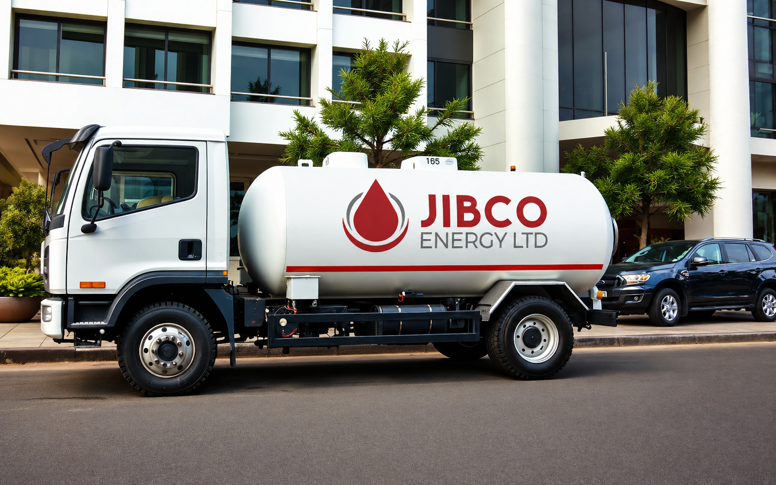 JIBCO Energy Ltd fuel delivery truck parked in front of a commercial building